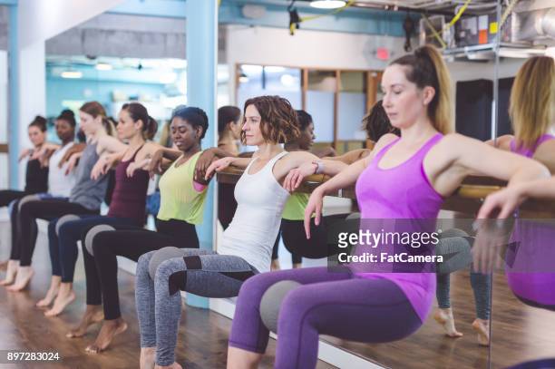 women doing barre workout together at modern gym - hesitant to dance stock pictures, royalty-free photos & images