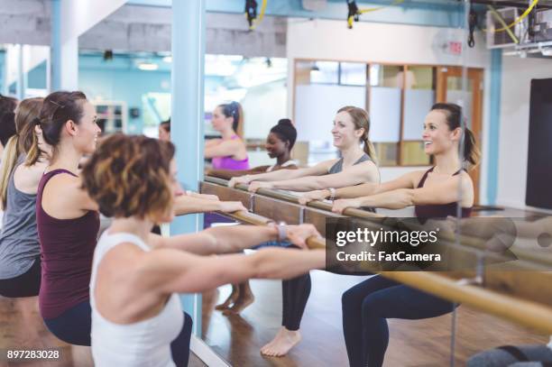 women doing barre workout together at modern gym - hesitant to dance stock pictures, royalty-free photos & images