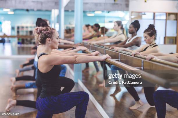 women doing barre workout together at modern gym - hesitant to dance stock pictures, royalty-free photos & images