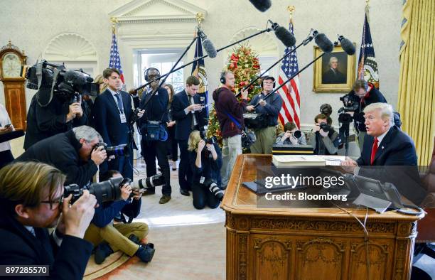 President Donald Trump speaks to members of the media after signing a tax-overhaul bill into law in the Oval Office of the White House in Washington,...