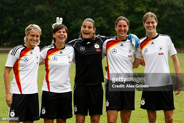 Saskia Bartusiak, Ariane Hingst, Nadine Angerer, Birgit Prinz and Kerstin Garefrekes make fun during a photo call of the German women's national...