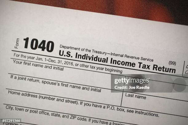 Copy of a IRS 1040 tax form is seen at an H&R Block office on the day President Donald Trump signed the Republican tax cut bill in Washington, DC on...