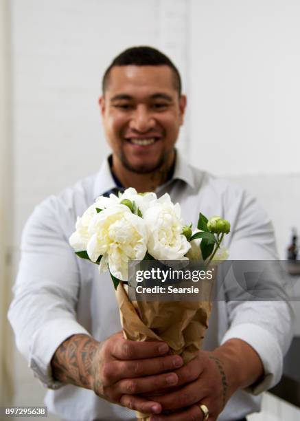 syd112017 man with flowers - searsie stock pictures, royalty-free photos & images