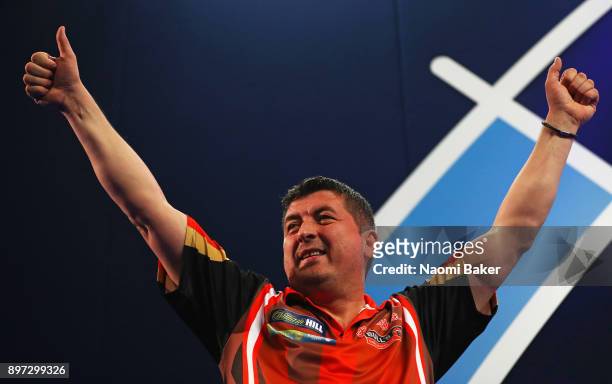 Mensur Suljovic of Austria appreciates the crowd as he walks on stage prior to the second round match against Robert Thornton of Scotland on day nine...