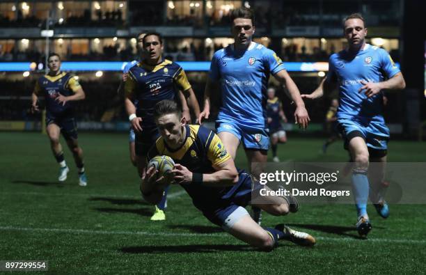 Josh Adams of Worcester Warriors dives over to score the first try during the Aviva Premiership match between Worcester Warriors and London Irish at...