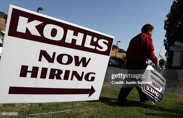 Kohl's employee Chris Torres sets up signs pointing to the Kohl's job fair at the Embassy Suites hotel August 10, 2009 in San Rafael, California....