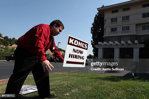 Kohl's employee Chris Torres sets up signs pointing to the Kohl's job fair at the Embassy Suites hotel August 10, 2009 in San Rafael, California....