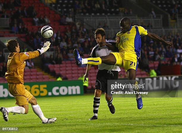 Enoch Showunmi of Leeds United beats David Knight of Darlington to score the opening goal during the Carling Cup First Round match between Darlington...