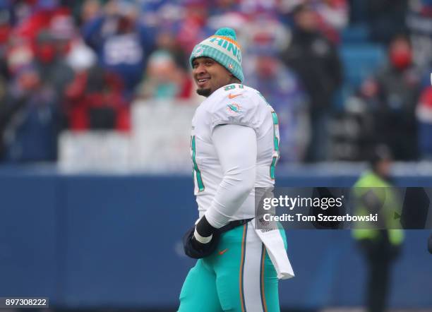 Mike Pouncey of the Miami Dolphins smiles as he takes the field during NFL game action against the Buffalo Bills at New Era Field on December 17,...