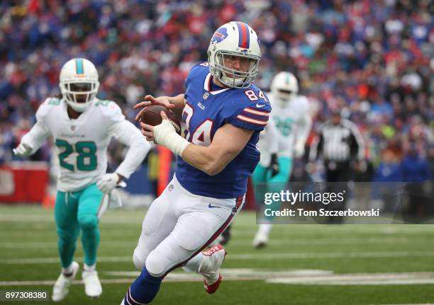 Nick O'Leary of the Buffalo Bills runs with the ball after making a reception during NFL game action against the Miami Dolphins at New Era Field on...