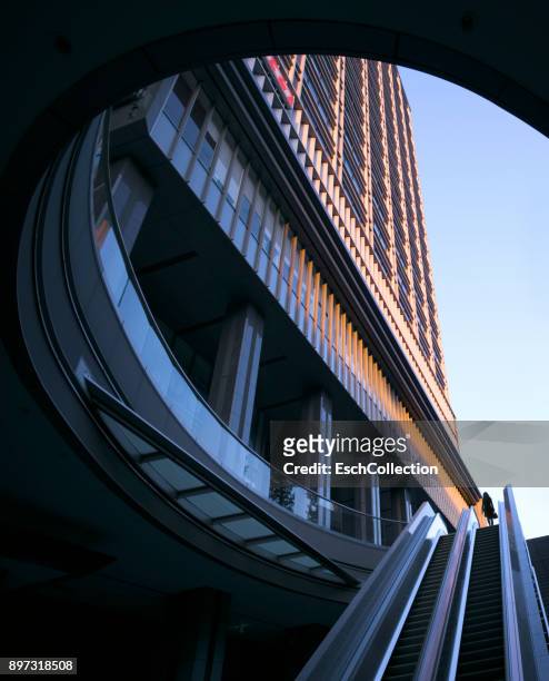 subway station exit with silhouette of woman at commercial district - circular business district stock-fotos und bilder