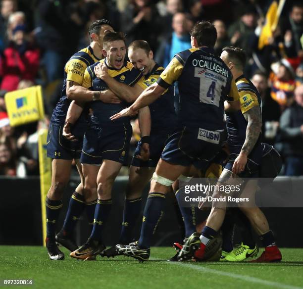 Josh Adams of Worcester Warriors is mobbed by team mates after scoring his second try during the Aviva Premiership match between Worcester Warriors...