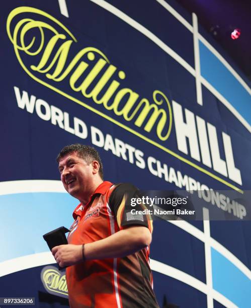 Mensur Suljovic of Austria walks off the stage after winning the second round match against Robert Thornton of Scotland on day nine of the 2018...