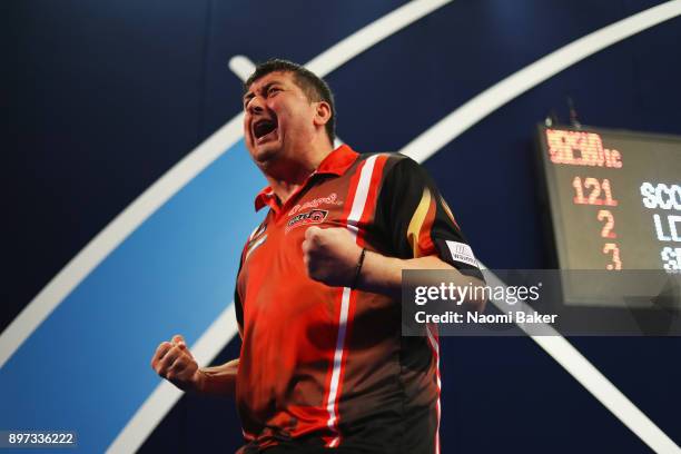 Mensur Suljovic of Austria celebrates winning the second round match against Robert Thornton of Scotland on day nine of the 2018 William Hill PDC...