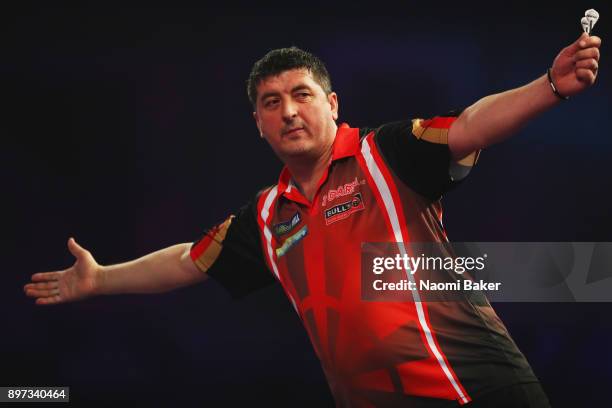 Mensur Suljovic of Austria celebrates after winning a set during the second round match against Robert Thornton of Scotland on day nine of the 2018...