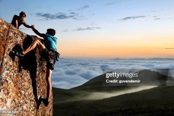 helping hikers - team climbing up to mountain top stock pictures, royalty-free photos & images