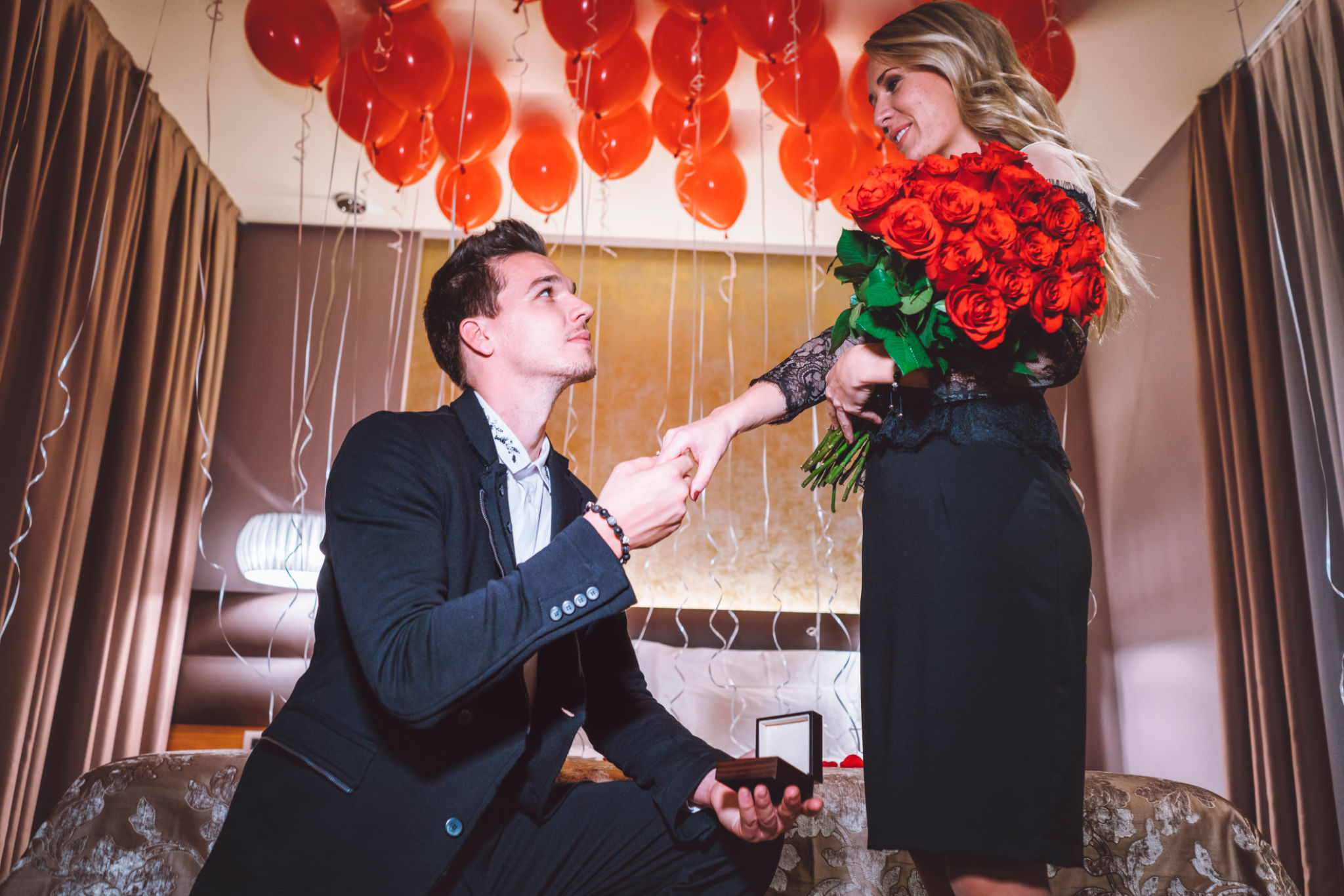 Young beautiful couple getting engaged in the luxurioius hotel Young beautiful couple getting engaged in the luxurioius hotel