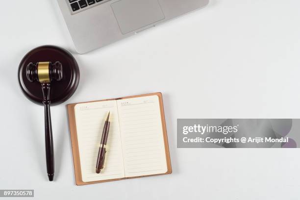 directly above view of modern law firm workplace with laptop, gavel and office articles - bid paddle stock pictures, royalty-free photos & images
