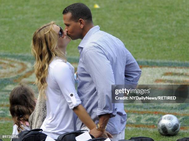 New York Yankees slugger Alex Rodriguez and actress Kate Hudson kiss at Yankees Family Picnic Day July 25, 2009 in New York City.