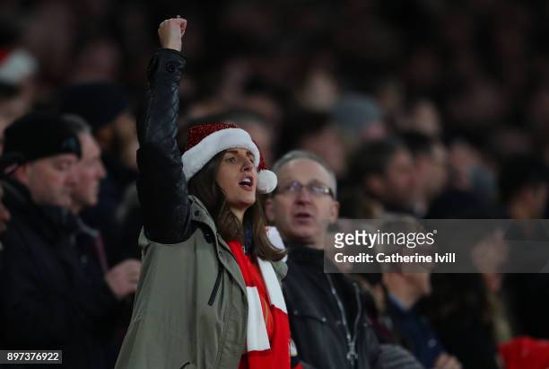 An Arsenal fan wearing a santa hat during the Premier League match between Arsenal and Liverpool at Emirates Stadium on December 22, 2017 in London,...