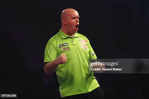 Michael van Gerwen of the Netherlands celebrates after winning the first leg during the second round match against James Wilson of England on day...