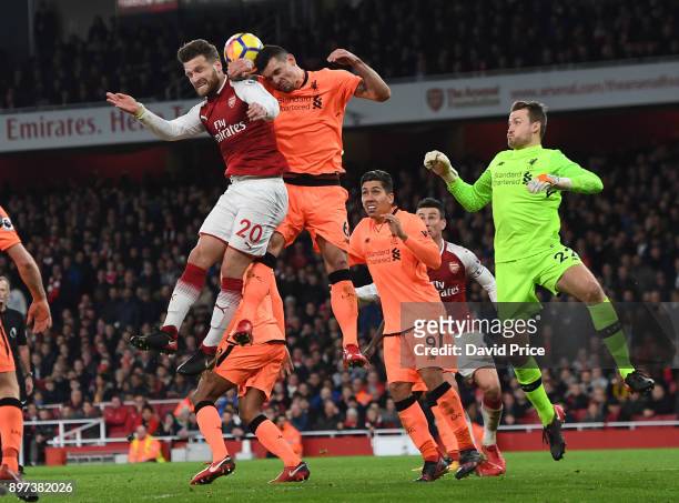 Shkodran Mustafi of Arsenal jumps with Dejan Lovren of Liverpool during the Premier League match between Arsenal and Liverpool at Emirates Stadium on...