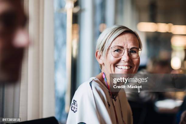 portrait of smiling businesswoman in cafe - 40 50 business woman stock pictures, royalty-free photos & images