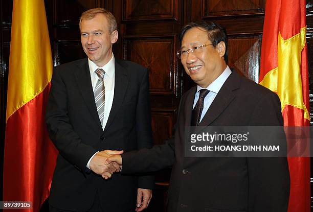 Visiting Belgian Foreign Minister Yves Leterme shakes hands with his Vietnamese counterpart Pham Gia Khiem as they meet at the government's guest...