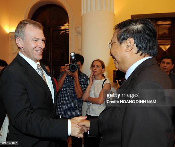 Visiting Belgian Foreign Minister Yves Leterme shakes hands with his Vietnamese counterpart Pham Gia Khiem as they meet at the government's guest...