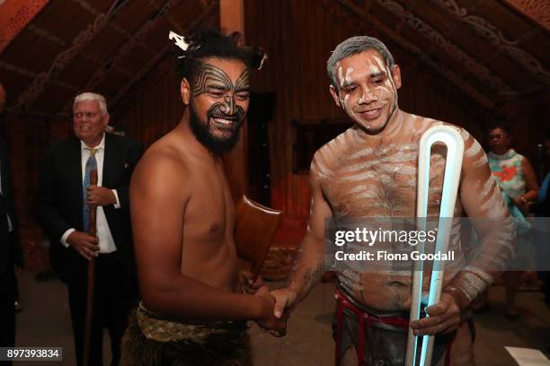 Jarred Fogarty of the Yugambeh clan receives the Queens Baton from a Maori Warrior at Auckland War Memorial Museum during the Commonwealth Games...