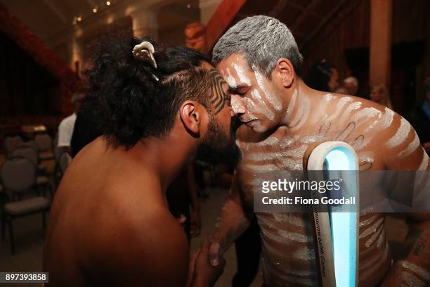 Jarred Fogarty of the Yugambeh clan receives the Queens Baton from a Maori Warrior at Auckland War Memorial Museum during the Commonwealth Games...