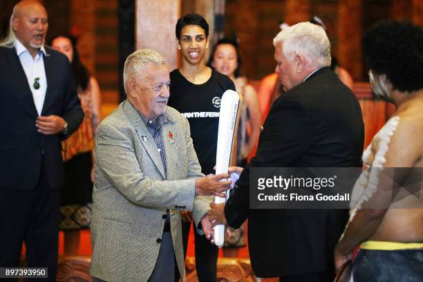 Uncle John Graham of the Yugambeh clan is handed the Queens Baton at Auckland War Memorial Museum during the Commonwealth Games Queens Baton Relay...