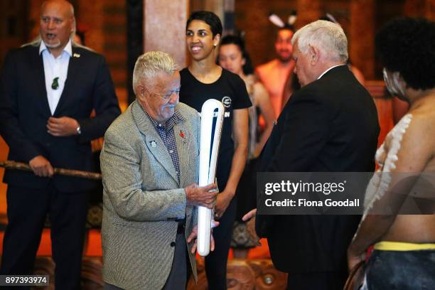 Uncle John Graham of the Yugambeh clan is handed the Queens Baton at Auckland War Memorial Museum during the Commonwealth Games Queens Baton Relay...