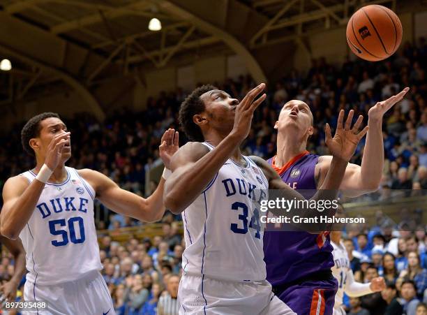 Wendell Carter Jr of the Duke Blue Devils battles Dainius Chatkevicius of the Evansville Aces for a rebound during their game at Cameron Indoor...
