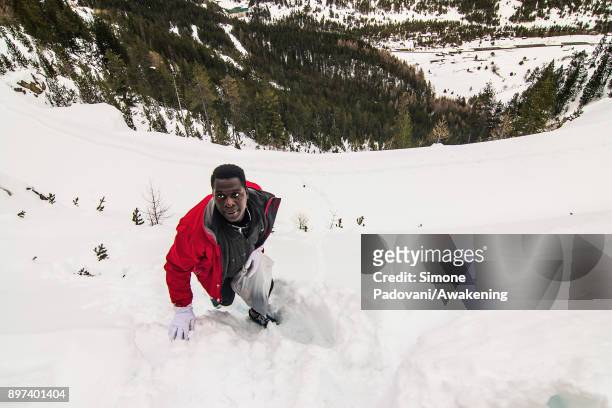 Migrant climbs Colle della Scala during an attempt to reach the French border on December 22, 2017 in Bardonecchia, Turin, Italy. After the police...