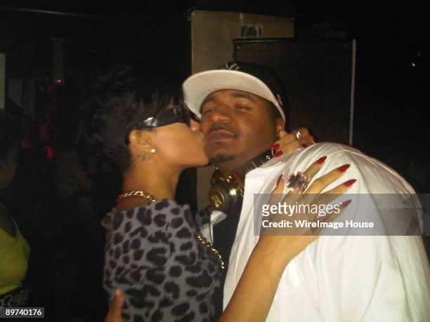 Rihanna gives a kiss to DJ Suss One of Power 105.1 FM at the Pink Elephant nightclub on August 9, 2009 in New York City.