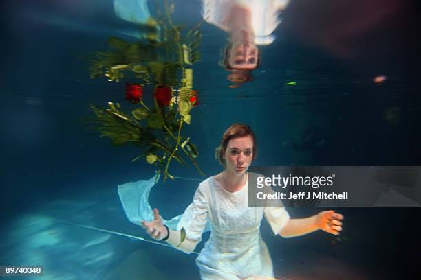 Helen Morton of the Three Bugs Fringe Theatre company performs Ophelia drowning in the Apex Hotel swimming pool during the Edinburgh Fringe Festival...