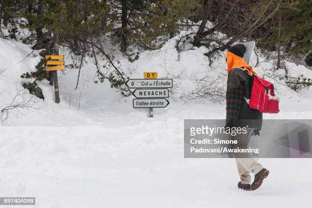 Migrant look at the signs after crossing the French border on December 22, 2017 in Bardonecchia, Turin, Italy. After the police reinforced the Frejus...