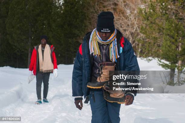 Migrants walks to reach another village after crossing the French border on December 22, 2017 in Bardonecchia, Turin, Italy. After the police...