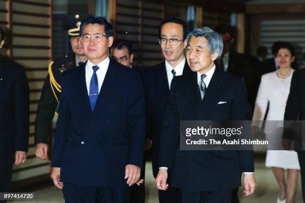 Peruvian President Alberto Fujimori and Emperor Akihito walk a corridor prior to their meeting at the Imperial Palace on March 16, 1992 in Tokyo,...
