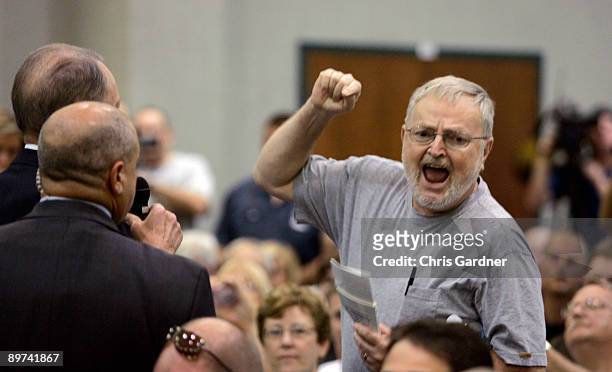 Sen. Arlen Specter listens as an unidentified man shouts at him during a town hall meeting August 11, 2009 in Lebanon, Pennsylvania. Specter held the...