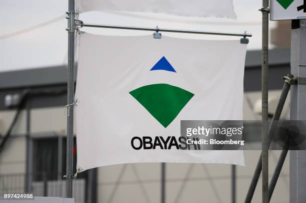 Logo of Obayashi Corp. Is displayed on a flag at a construction site in Tokyo, Japan, on Friday, Dec. 22, 2017. Japan's major construction companies,...