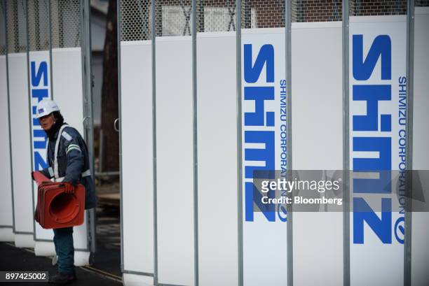 Logos of Shimizu Corp. Are displayed on a fence at a construction site in Tokyo, Japan, on Friday, Dec. 22, 2017. Japan's major construction...