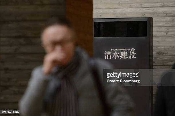 Pedestrian walks past a Shimizu Corp. Logo displayed at the company's headquarters in Tokyo, Japan, on Friday, Dec. 22, 2017. Japan's major...