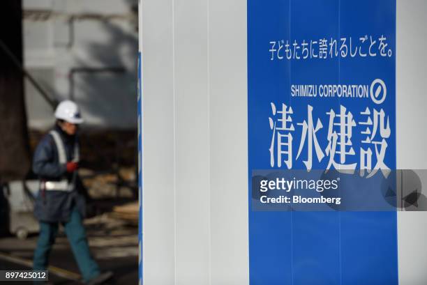 Logo of Shimizu Corp. Is displayed on a fence at a construction site in Tokyo, Japan, on Friday, Dec. 22, 2017. Japan's major construction companies,...