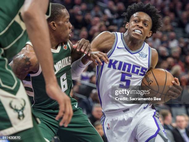 The Sacramento Kings' De'Aaron Fox drives to the basket against the Milwaukee Bucks' Eric Bledsoe on November 28 at Holden 1 Center in Sacramento,...