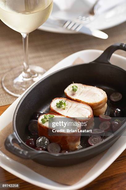 prosciutto wrapped sea bass with grape sauce - prosciutto wrapped stock pictures, royalty-free photos & images
