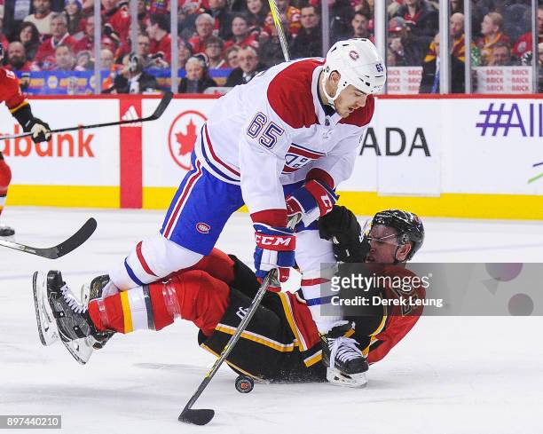 Andrew Shaw of the Montreal Canadiens checks Michael Stone of the Calgary Flames during an NHL game at Scotiabank Saddledome on December 22, 2017 in...