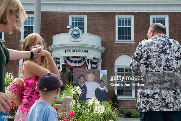 People walk near a photograph of Eunice Kennedy Shriver outside the John F. Kennedy Museum August 11, 2009 in Hyannis, Masachusetts. Eunice Kennedy...