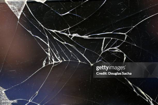 fbroken screen on a mobile device - broken glass pieces stock pictures, royalty-free photos & images